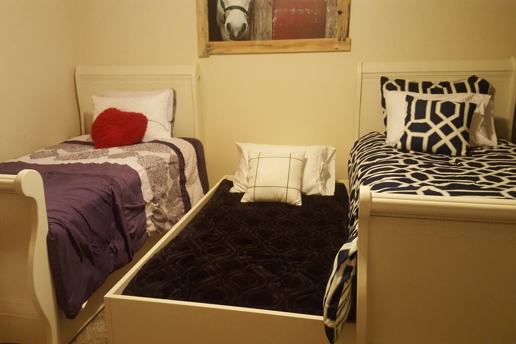 Horse bedroom with one trundle out. Second trundle can be pulled to the bottom of the beds. It's a tight fit but 4 people can sleep here.