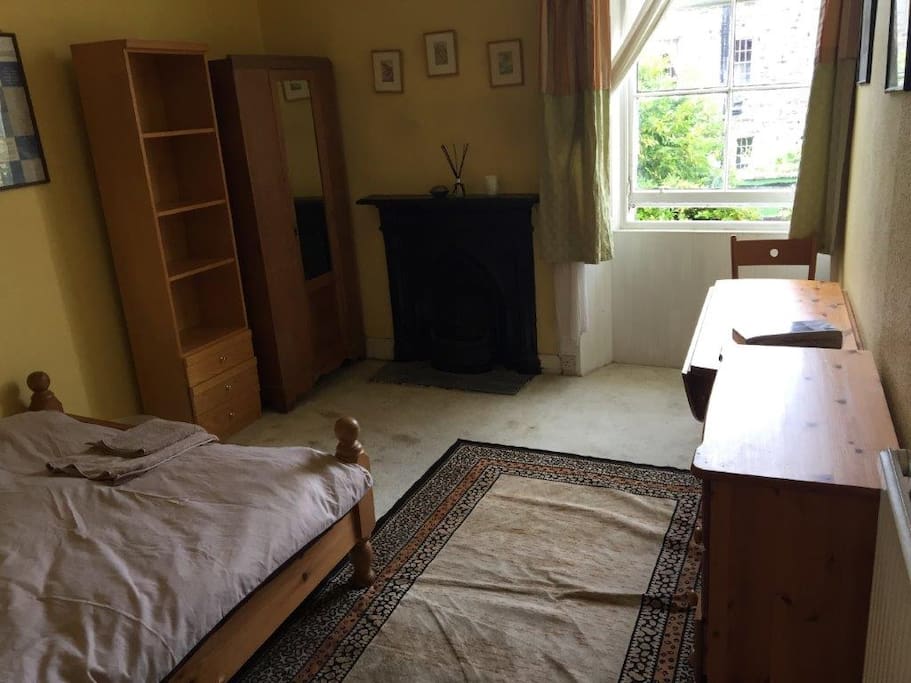Your bedroom with original fireplace, view to back garden