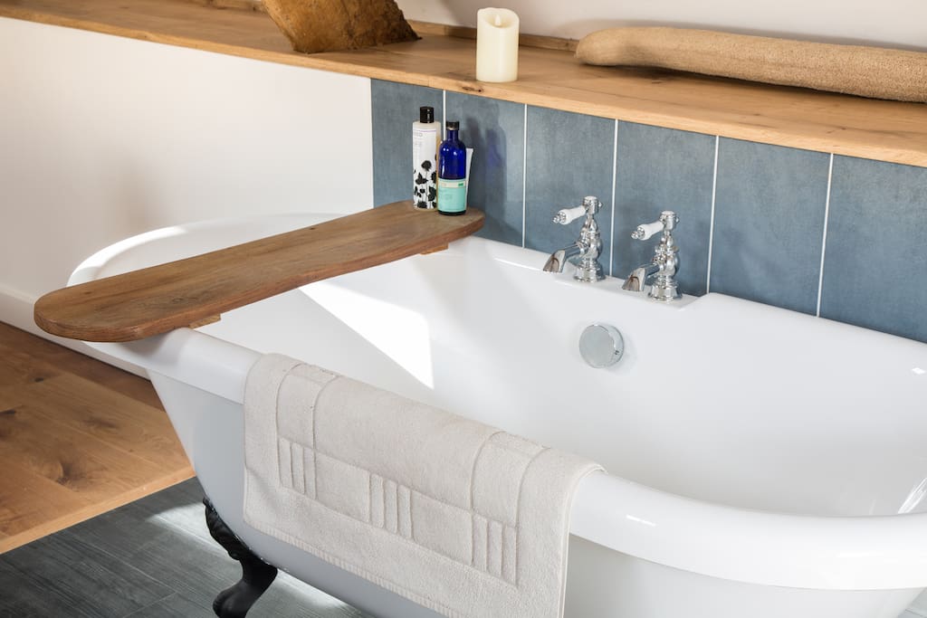 The rolltop bath...with a handmade bath caddy and alarmingly realistic electric wax candles