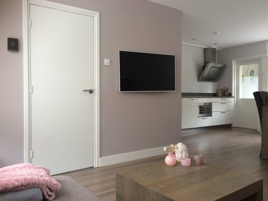 From Livingroom to kitchen. Behind the door in the back you enter the laundry room and shower + toilet