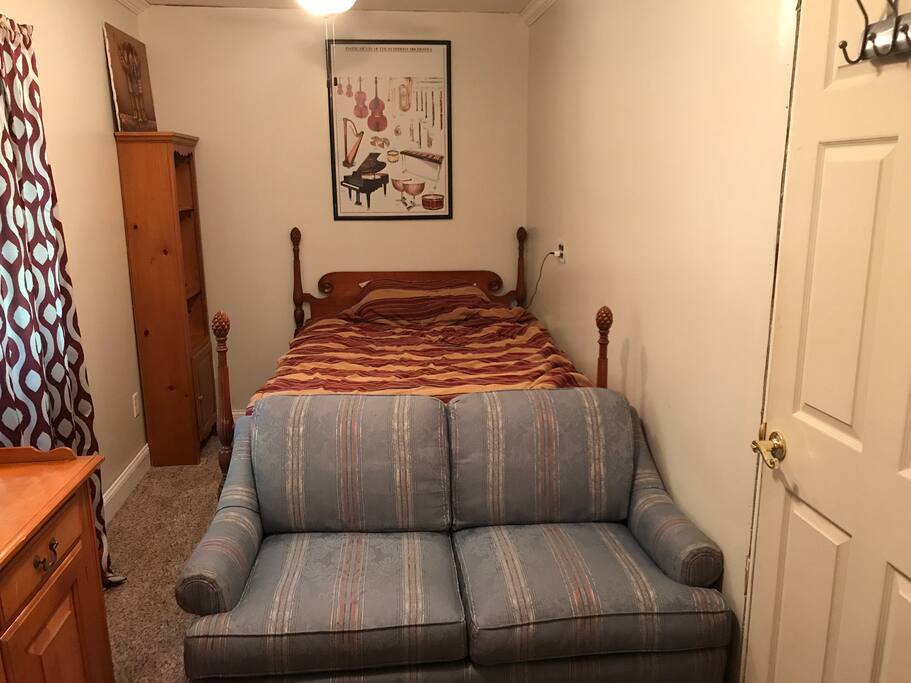 Love seat and cable TV mounted on wall