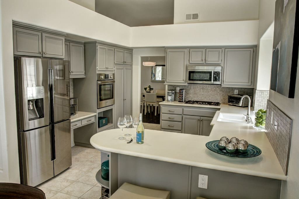 Modern kitchen with new high end Bosch appliances, fully stocked with everything you need to cook and enjoy tour time inside or outside!