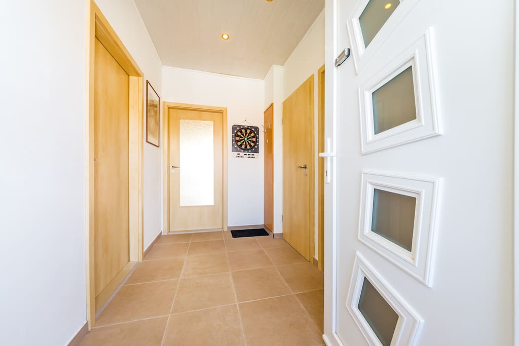 This is the entrance hall with shoes cabinet and electronic darts game