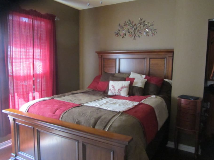 Bedroom 1 - This is the bigger of the 2 rooms. It has a comfy queen bed, a night stand available for your use, a 42" tv with Roku and a small blue chair. There is also a portable A/C unit for those hot hot Texas days.