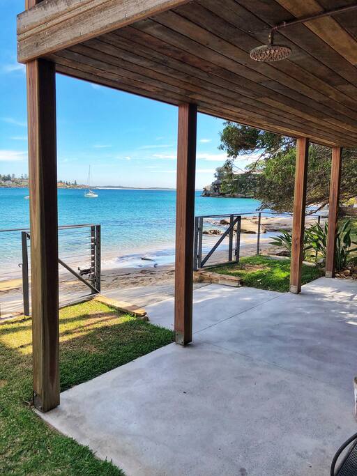 The front lawn, outdoor shower and beach access.