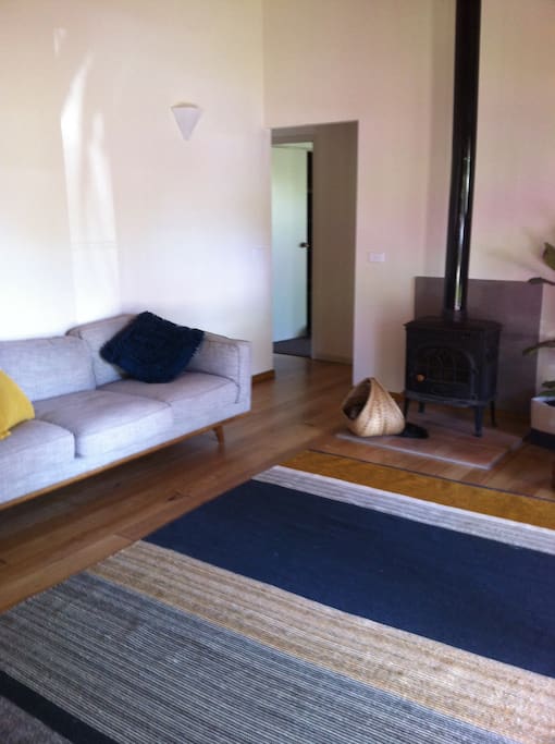 Bright, fresh lounge room with wood fire in the colder months