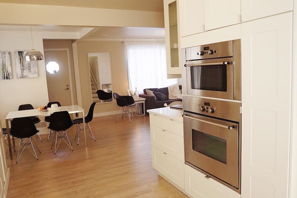 Open concept floor with kitchen area ( stove and microwave on right), and dining area