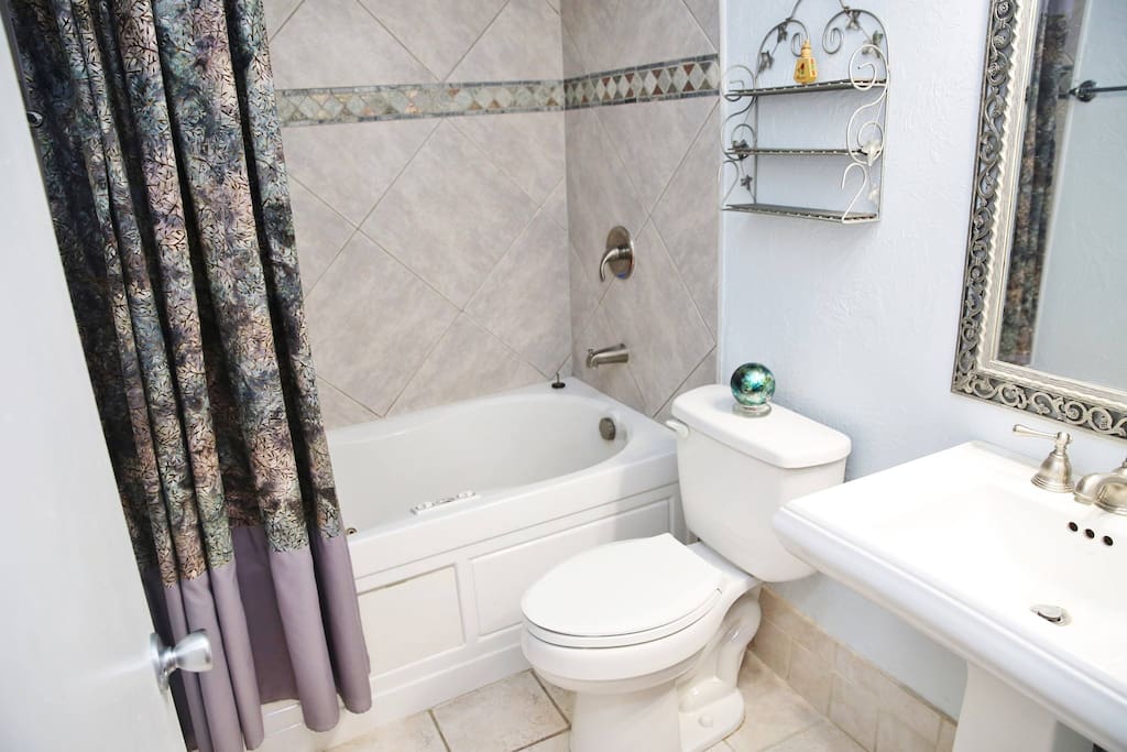 Full private bathroom with "Jacuzzi" style bath tub/shower.