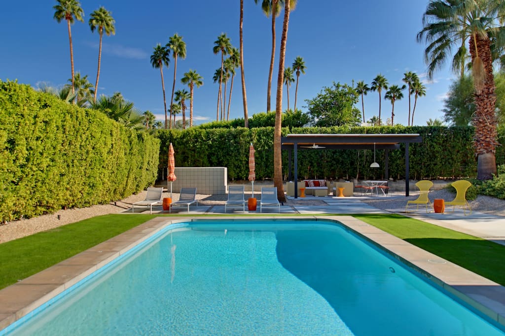 Getting too hot for you? Relax under the poolside umbrellas or covered patio!
