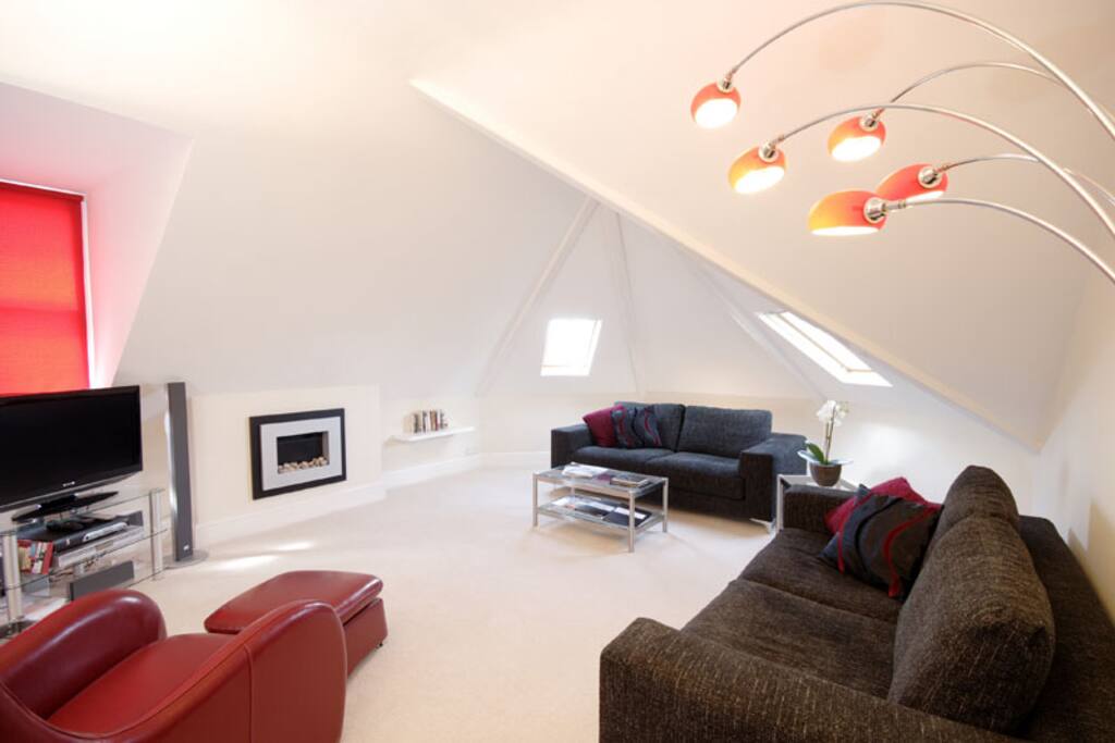 Spacious lounge, with TV, MP3 player, DVD player, modern wall mounted electric fireplace. Comfortable seating and good lighting.