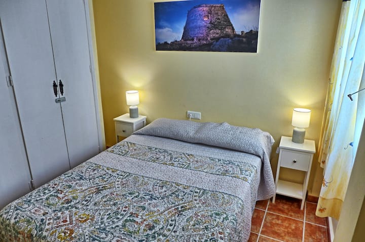 Bedroom four with 135cm wide double bed, wardrobe, air conditioning, ceiling fan and window shutters. This bedroom has an internal patio view (not a view of the square) and as a result is quieter than the other bedrooms.