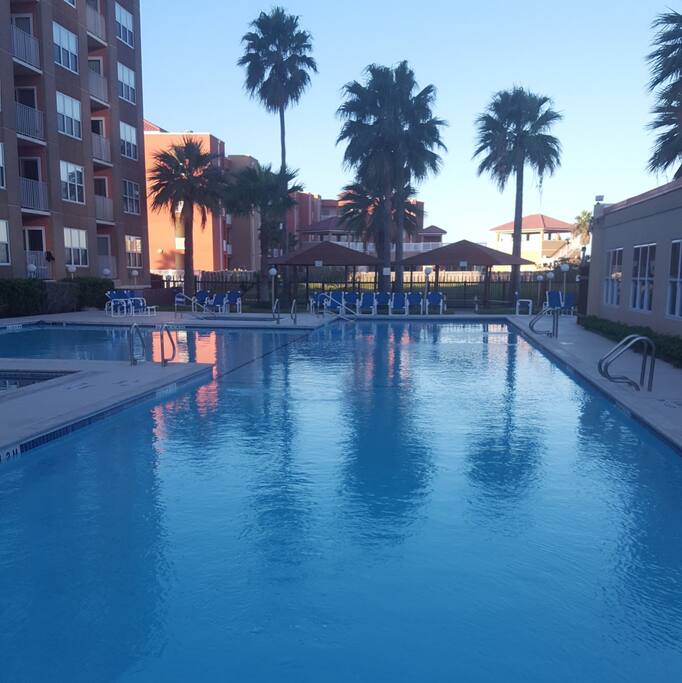 Large pool area. Jacuzzi on left. Kids pool up top. BBQs, swimming, laying in the sun