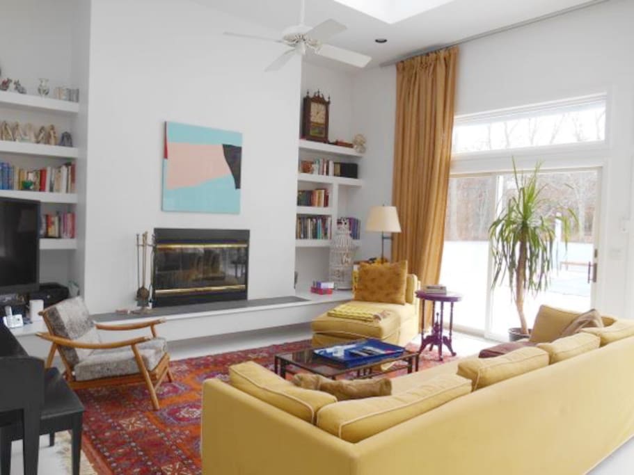 Living room. 18' ceilings, flat screen TV with premium cable. Skylights above, and sliding doors to pool and patio