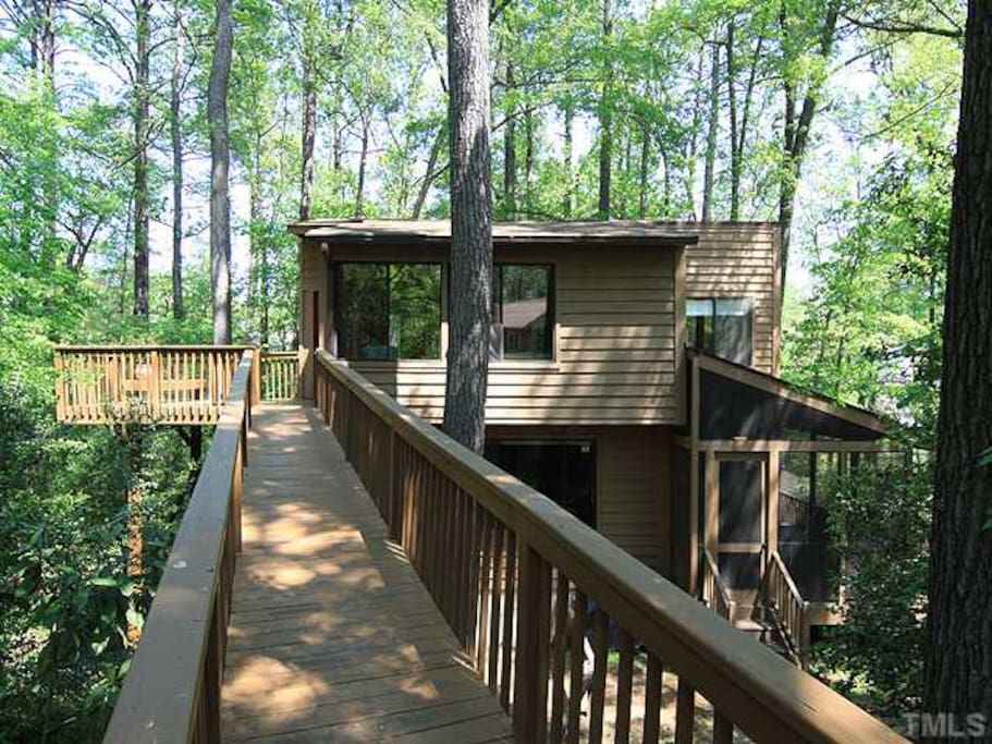 Front of the house with ramp to upstairs and a deck