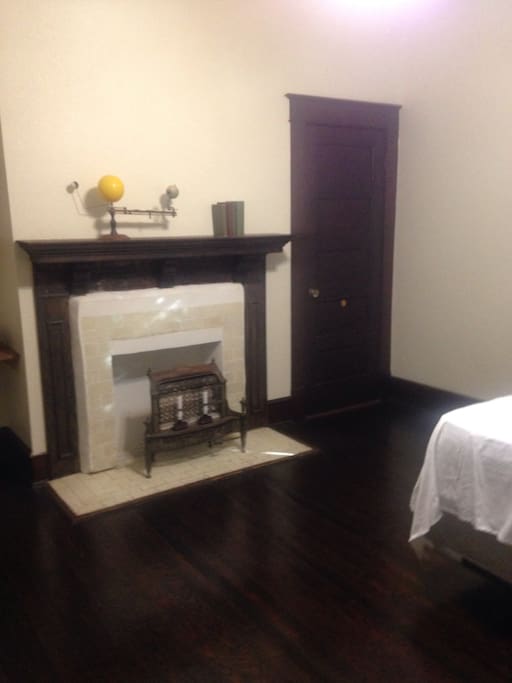 Roomy downstairs bedroom with decorative (non-functional) fireplace.