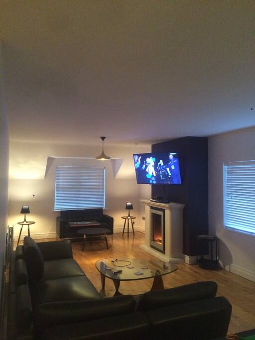 Living room space with 64 inch smart TV.