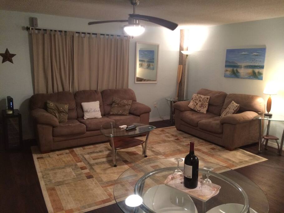 Spacious living room with a couch with queen sized pull out. Also features a flat screen TV and sliding glass door to over sized balcony with ocean view. Free wifi.