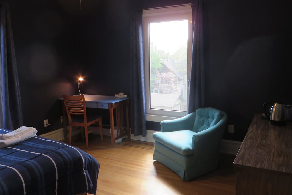 The Blue room is on the second level and has a queen bed, mini fridge, kettle and small desk
