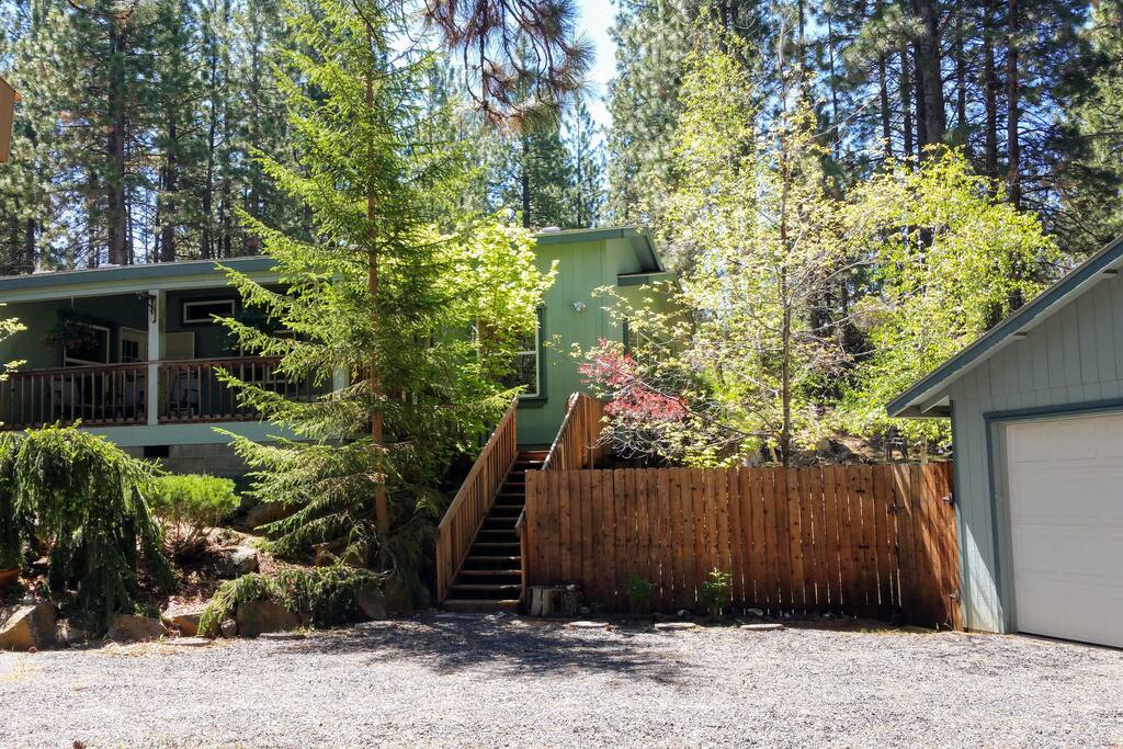 Stairs with gate and landing with large front porch