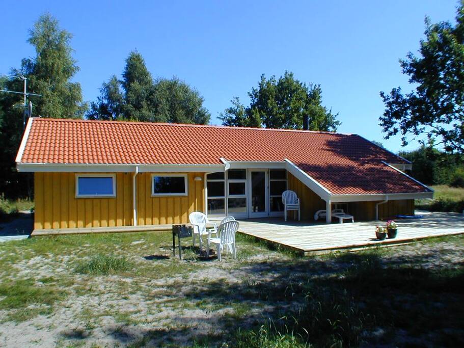Cottage with terrace and surroundings.
