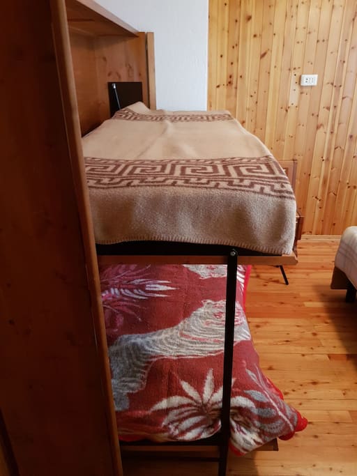 camera da letto con letto matrimoniale e due letti singoli a scomparsa