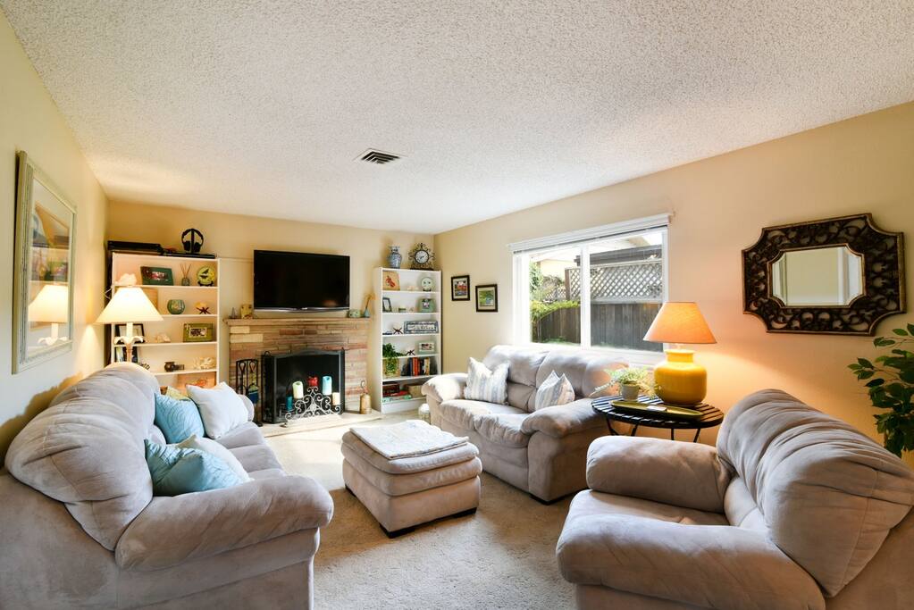 The living room has a large flat screen TV and DVD