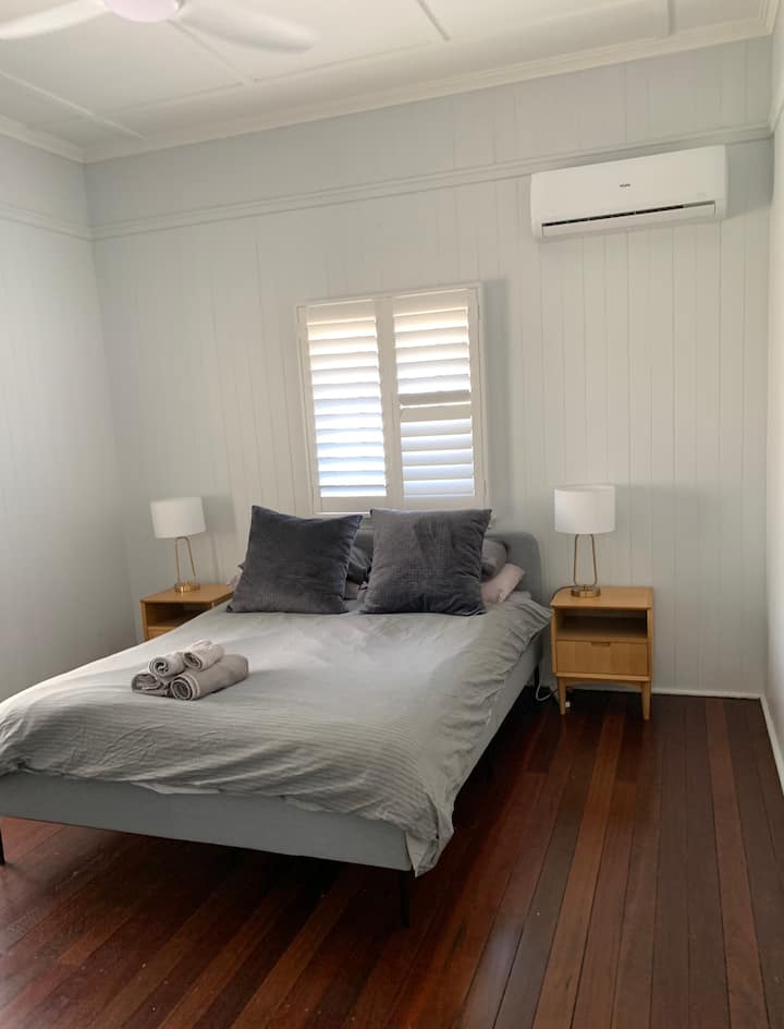 Spacious bedroom with Queen Size bed, aircon, ceiling-fan and roomy inbuilt robe with plenty of hanging space. 