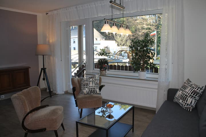 Living room with garden and balcony view