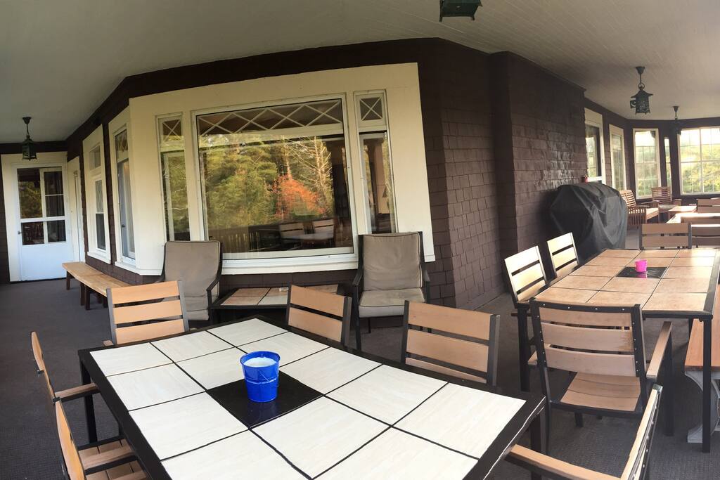 Covered Porch with 6 burner gas grill overlooking Lake Placid, seats 35