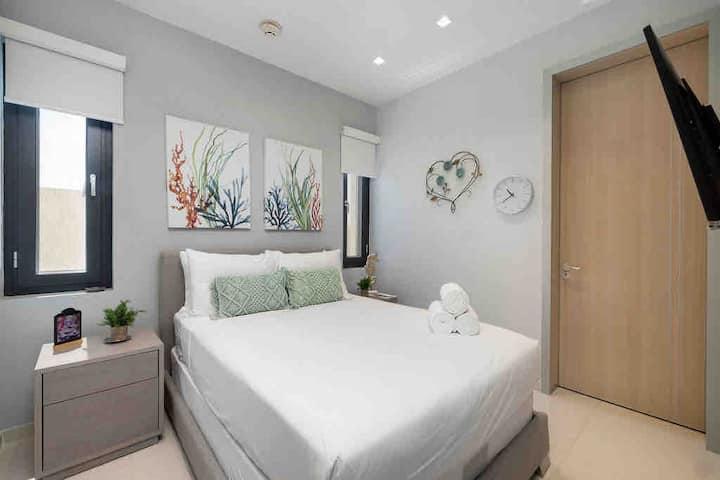 Bedroom with attached bathroom and smart TV