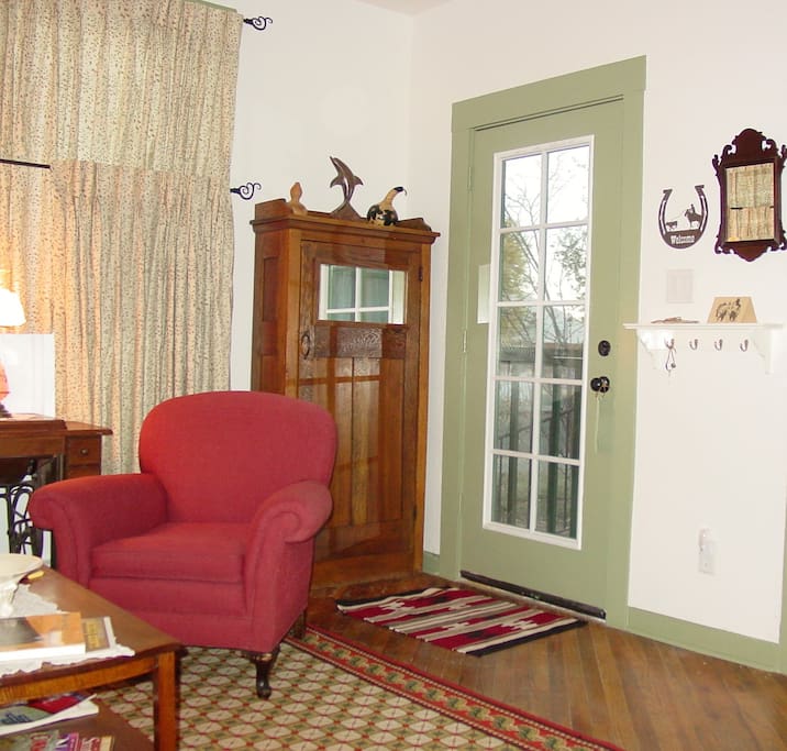 Antique coat closet next to front door in living room