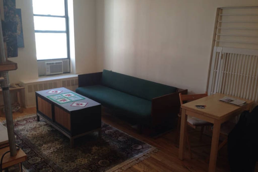 AC keeping it chilllll, places to sit, but the rug really ties the room together