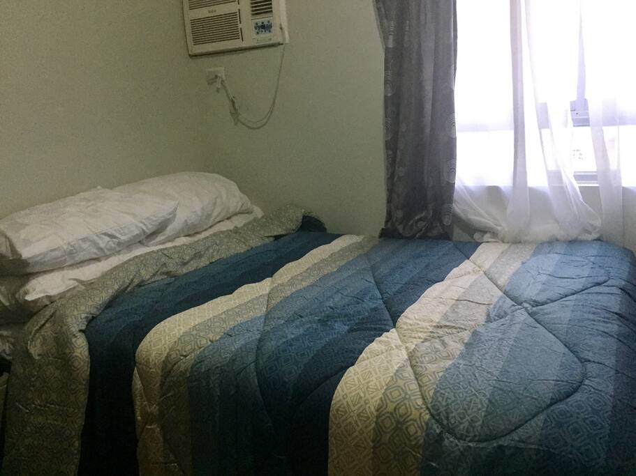 comfy queen size bed with king size pillows and comforter/blanket