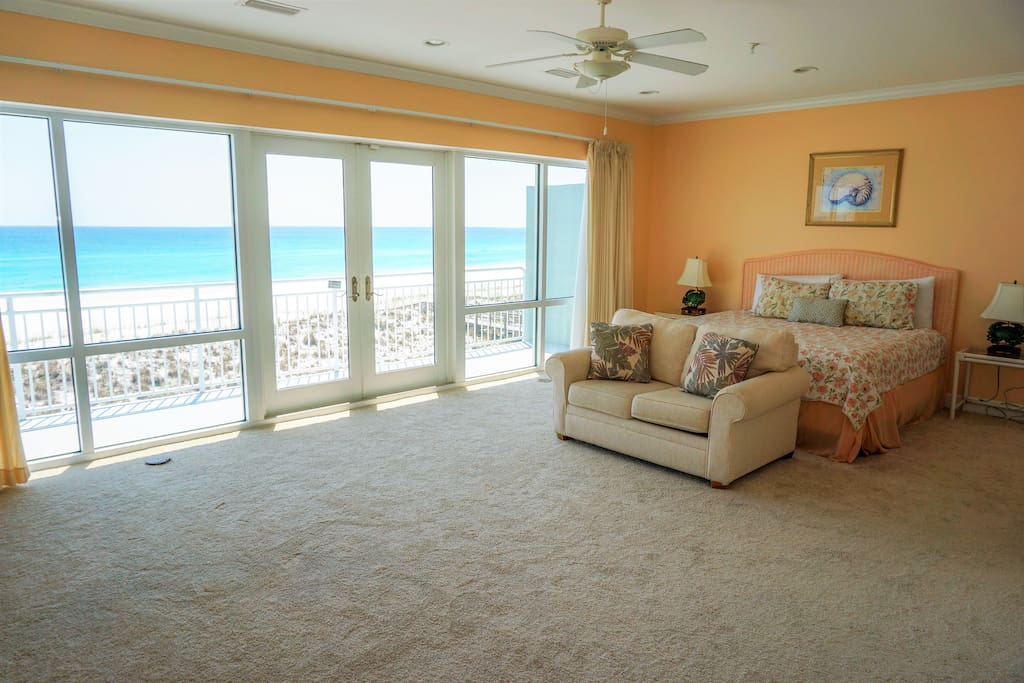 Master bedroom with king size bed and access to balcony overlooking emerald waters and sugar white sand beaches