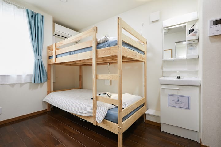 Room with bunk bed, vanity and toilet room