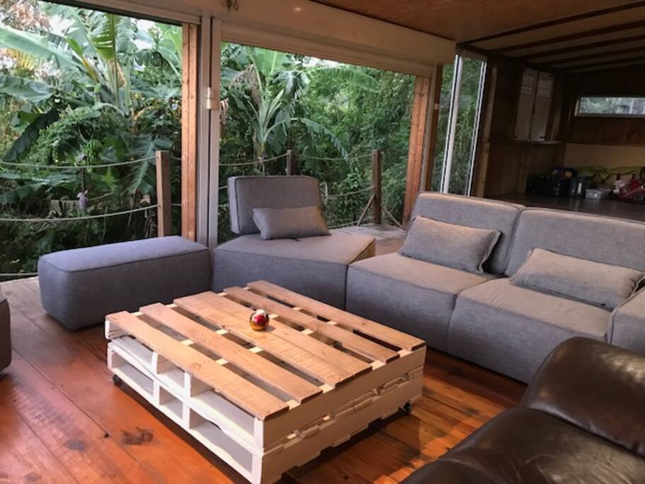 Le séjour est une terrasse ouverte, rideaux roulants en contact direct avec l'extérieur.