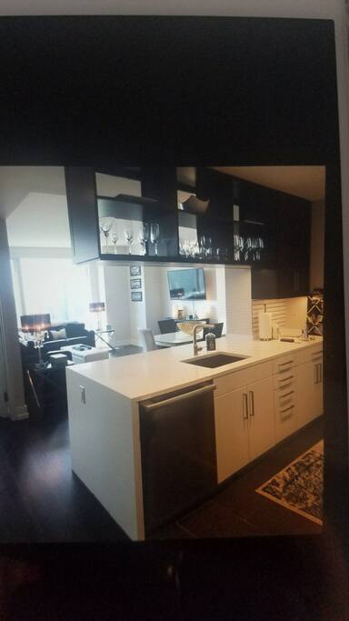 Oversized chef's kitchen looking into enormous living room