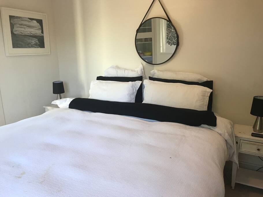 King-sized bedroom with french doors opening onto courtyard