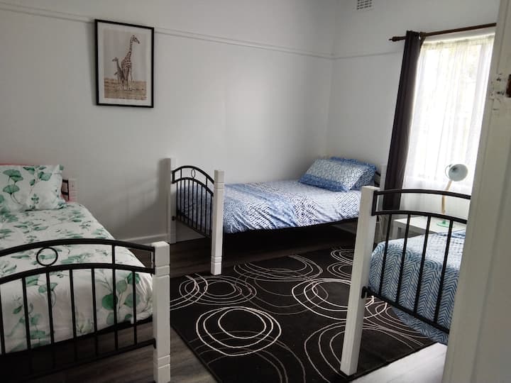Bedroom with 3 single beds, two have electric blankets
