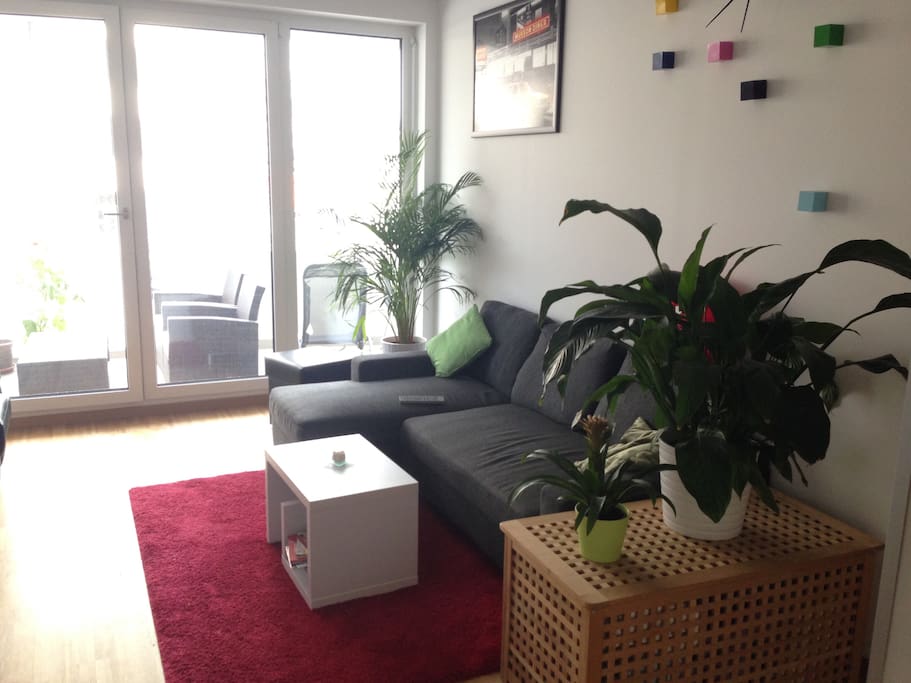 Living room with window to sunny balcony.