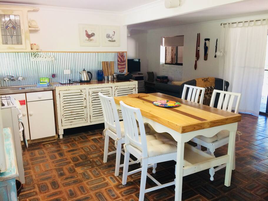 Kitchen with fridge, microwave, toaster, kettle and electric hotplate