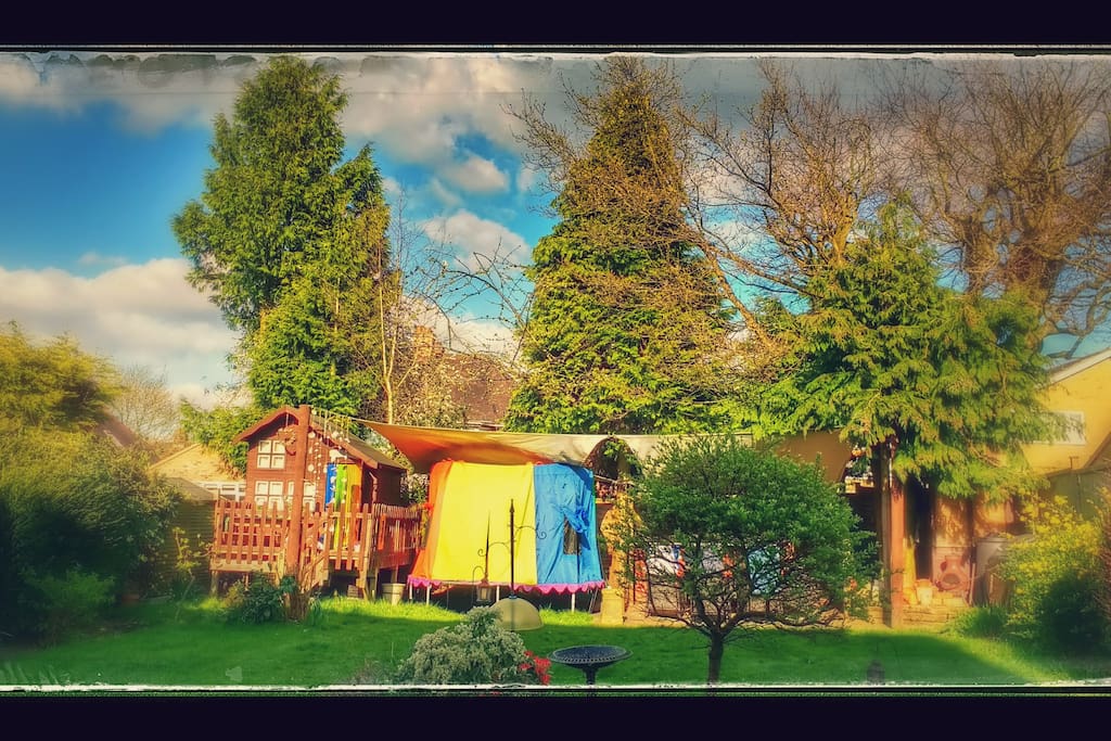 Double doors in kitchen lead out onto lawned garden with play house, trampoline, bbq and seating area.