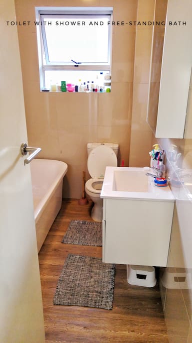 Bathroom with free-standing bath and shower.