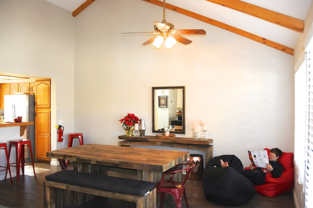 Reclaimed wood table and benches plus kitchen bar provide seating for all. "Beanbag Corner" in the dining room is perfect for a card game or a good book.