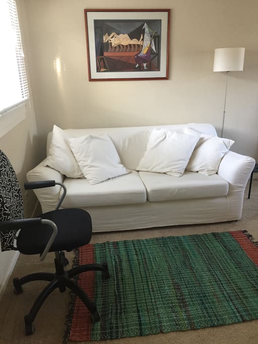 Sofa and desk chair in living area