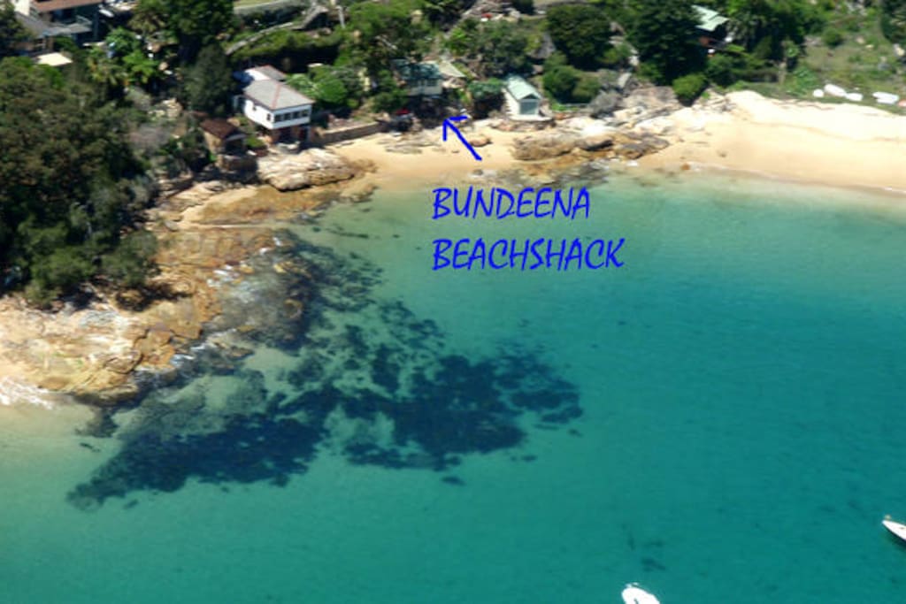 Helicopter view showing the Beachshack perched on the beachfront