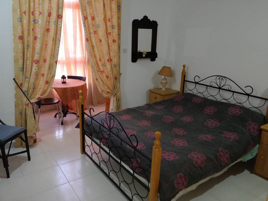 Main bedroom with closed balcony but can open windows