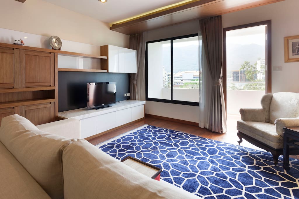 Large living room with the view of Doi Suthep. Sofa can be converted into a full size bed.