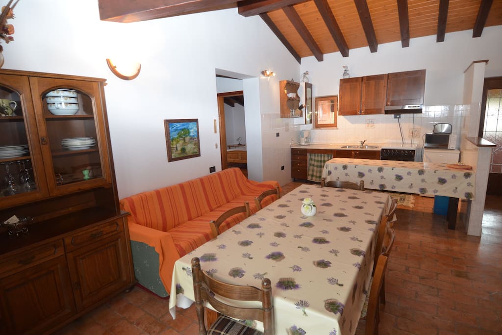 The living room and the kitchen are located in the same room, with an additional bed for two persons