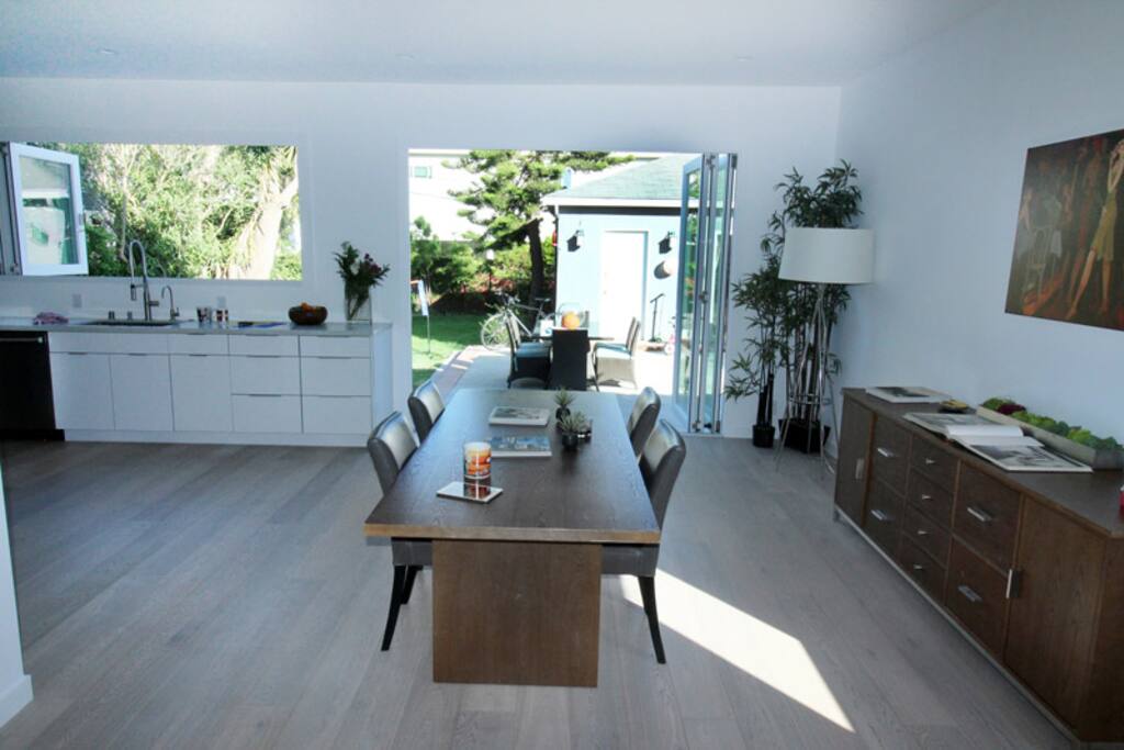 Giant folding patio doors open to breezy backyard